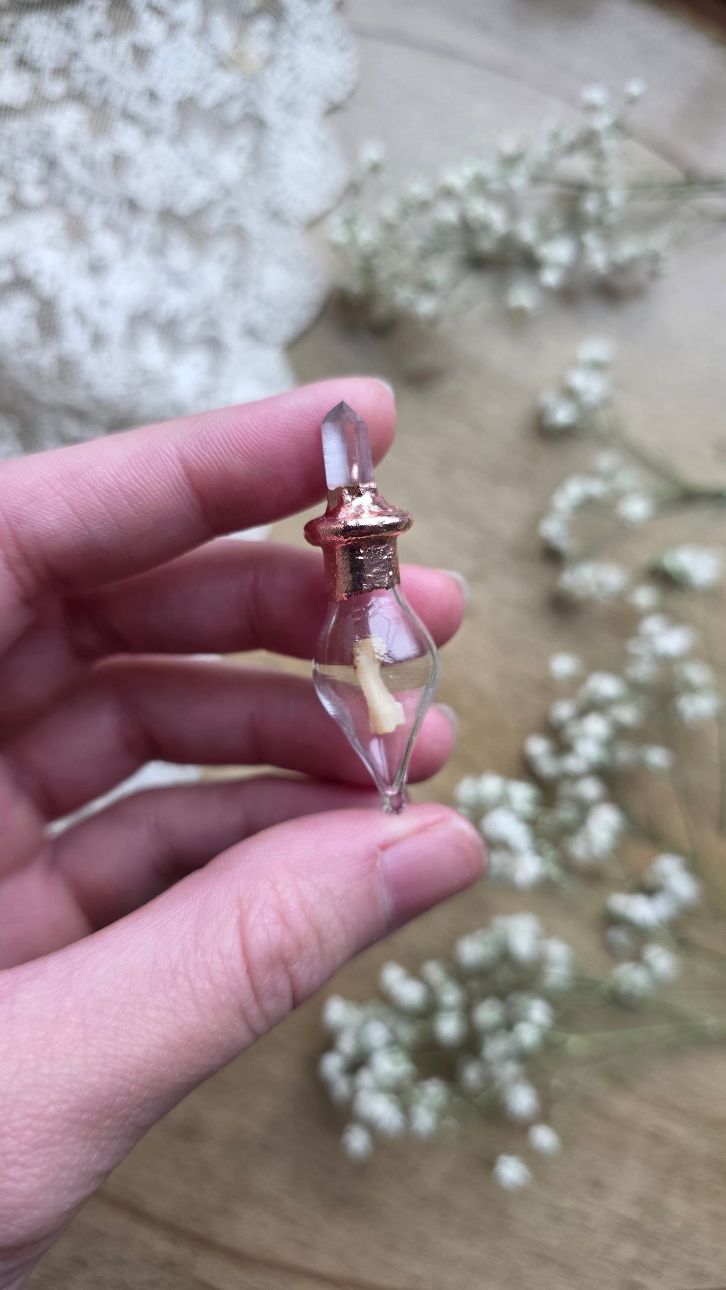 Black cat toe bone copper vial necklace.