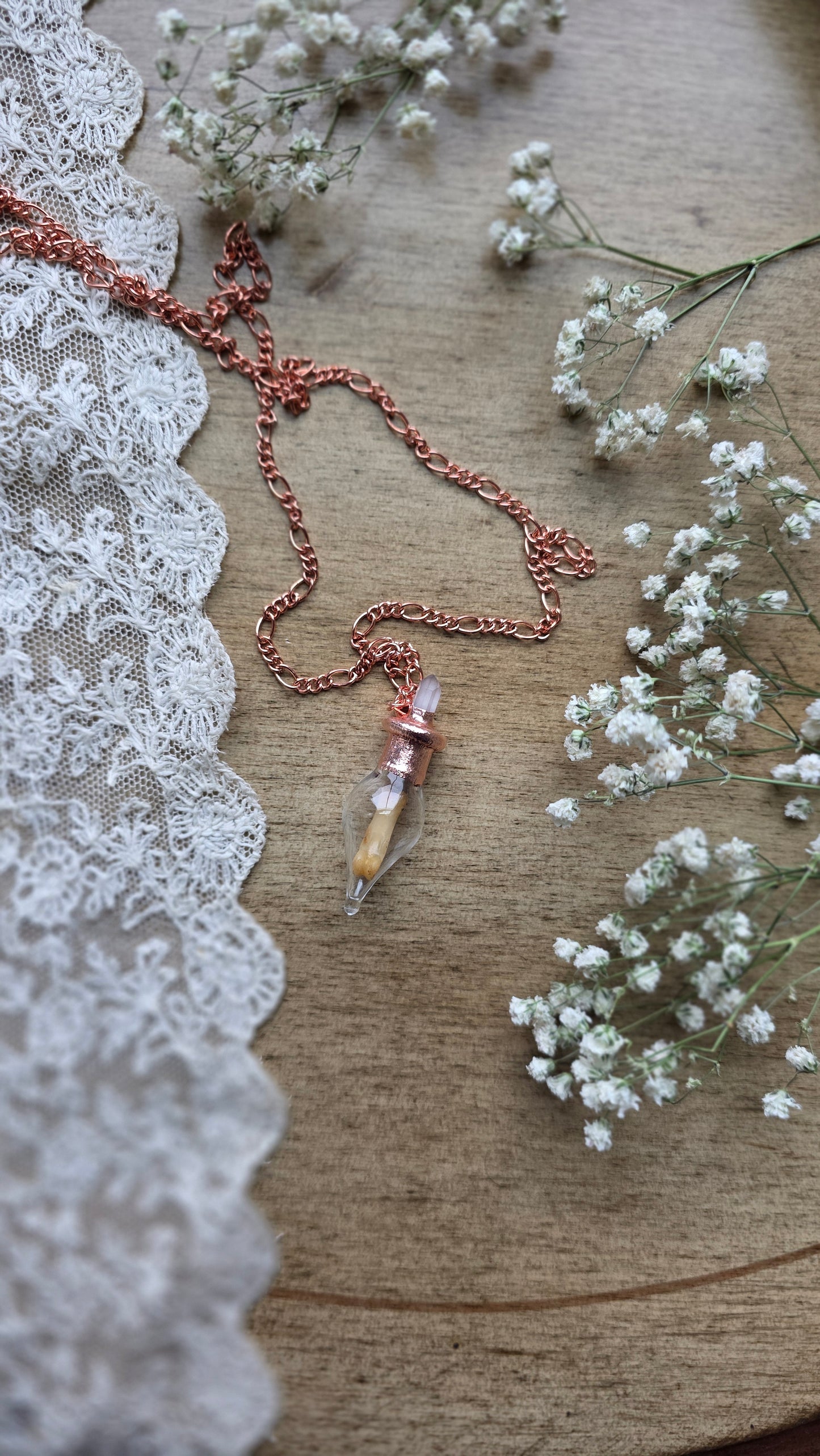 Black cat toe bone copper vial necklace.