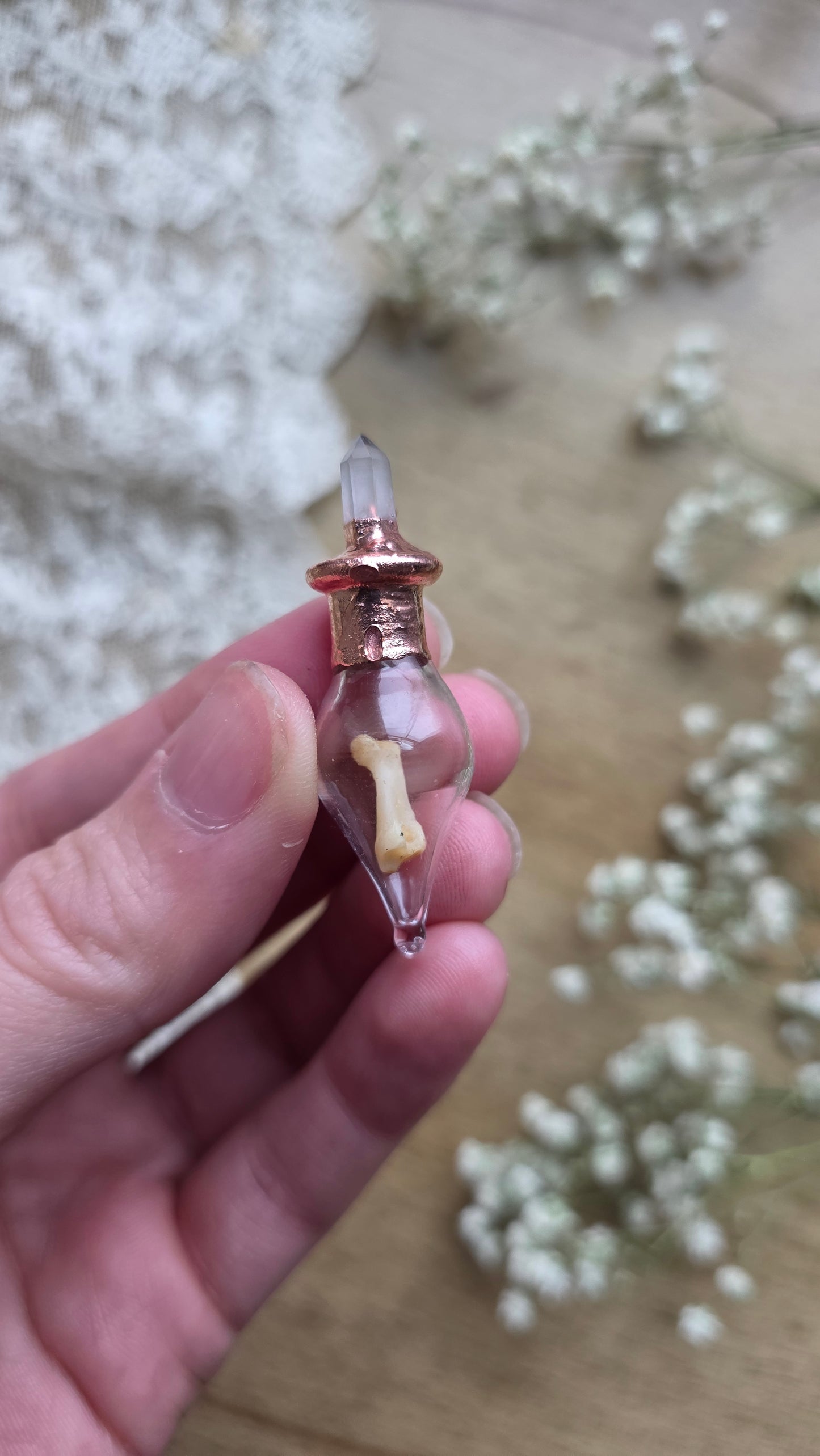 Black cat toe bone copper vial necklace.