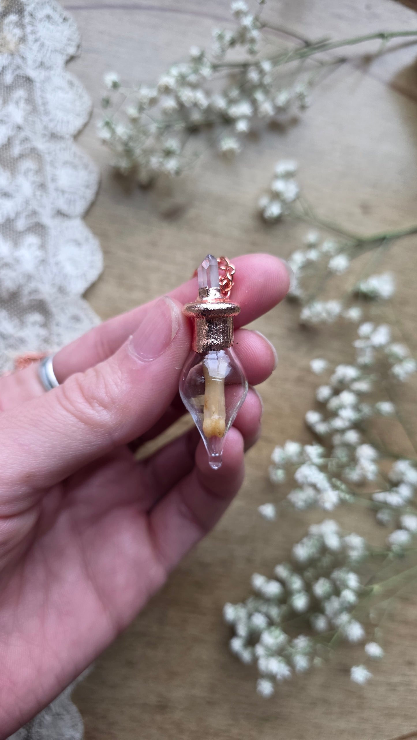 Black cat toe bone copper vial necklace.