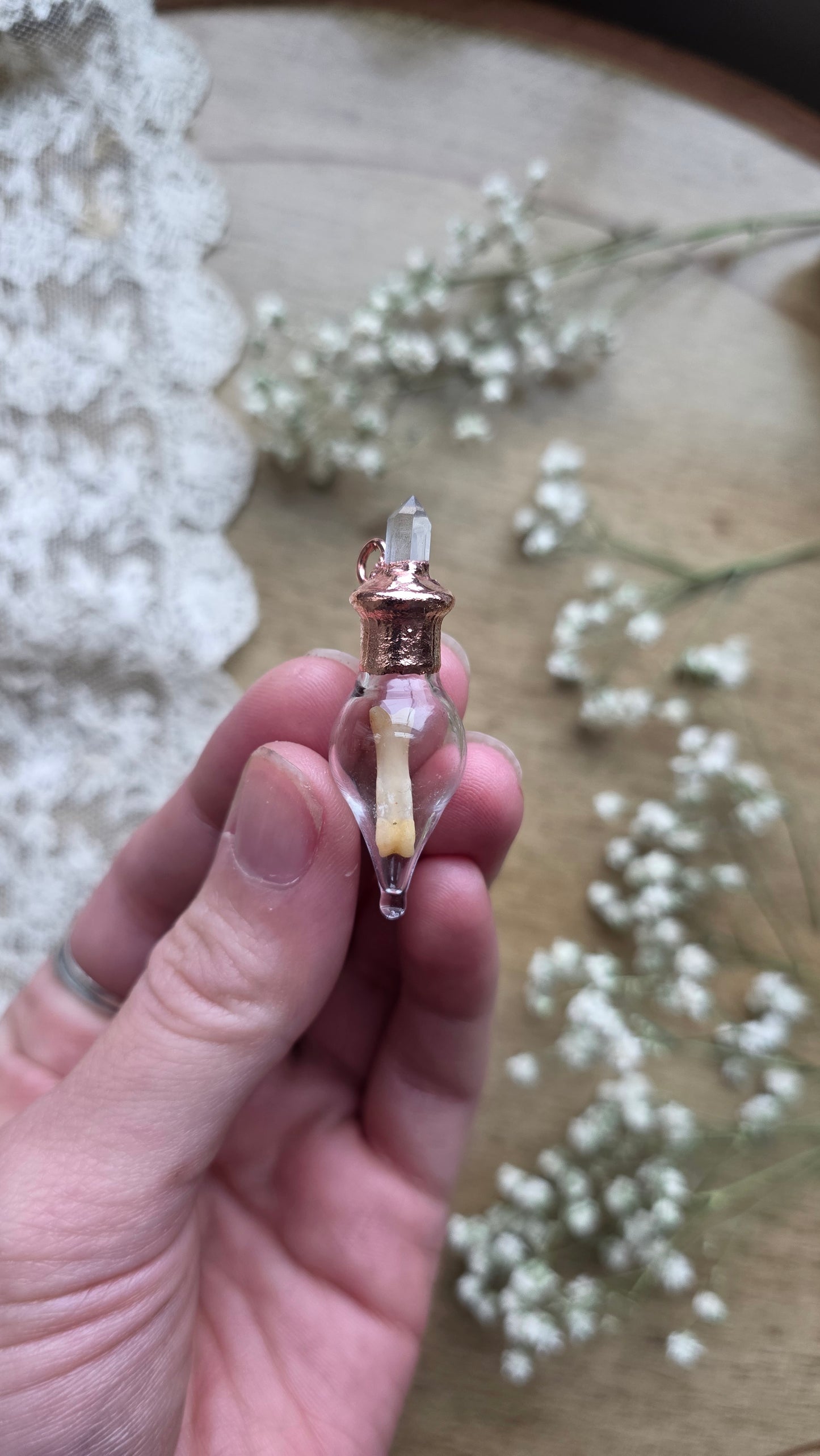 Black cat toe bone copper vial necklace.