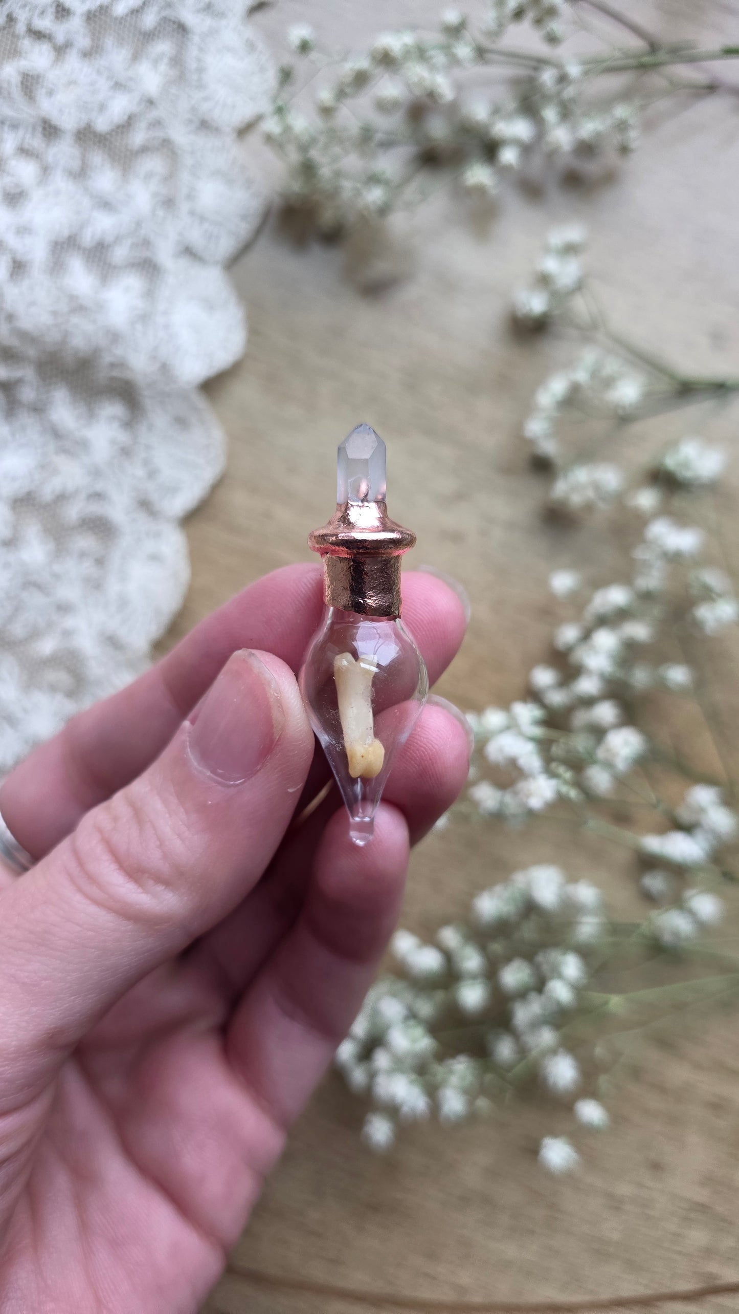 Black cat toe bone copper vial necklace.