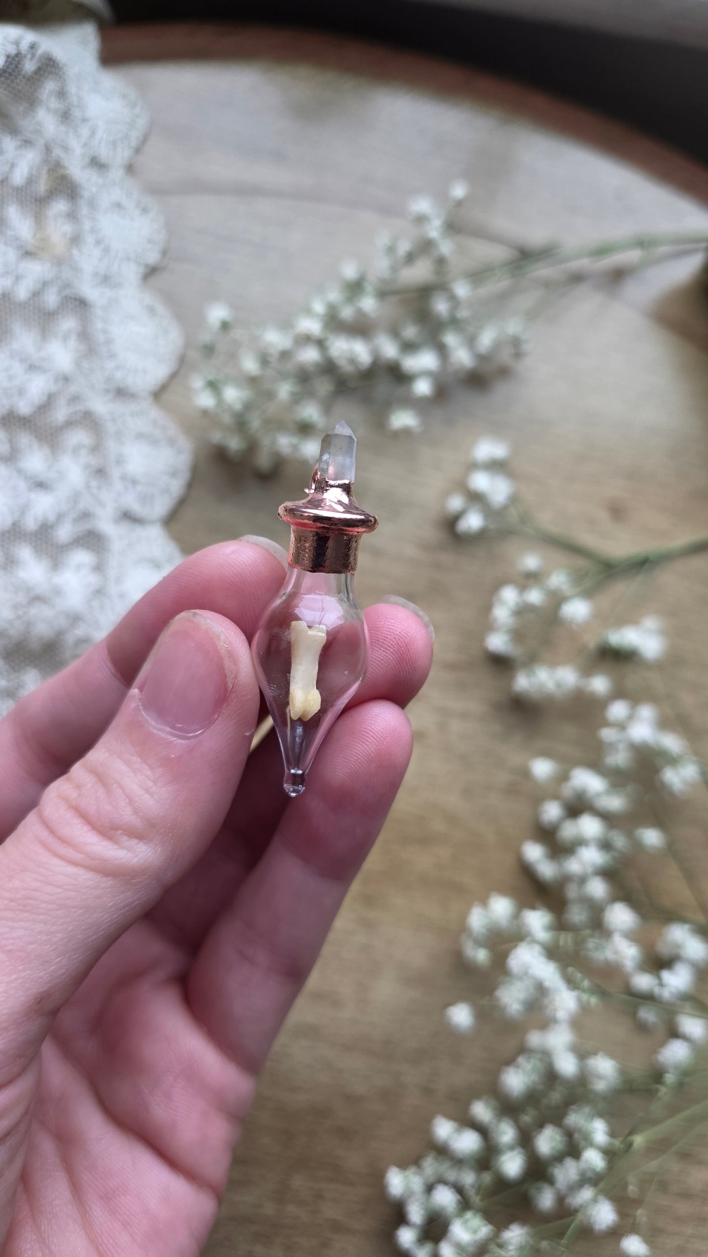 Black cat toe bone copper vial necklace.