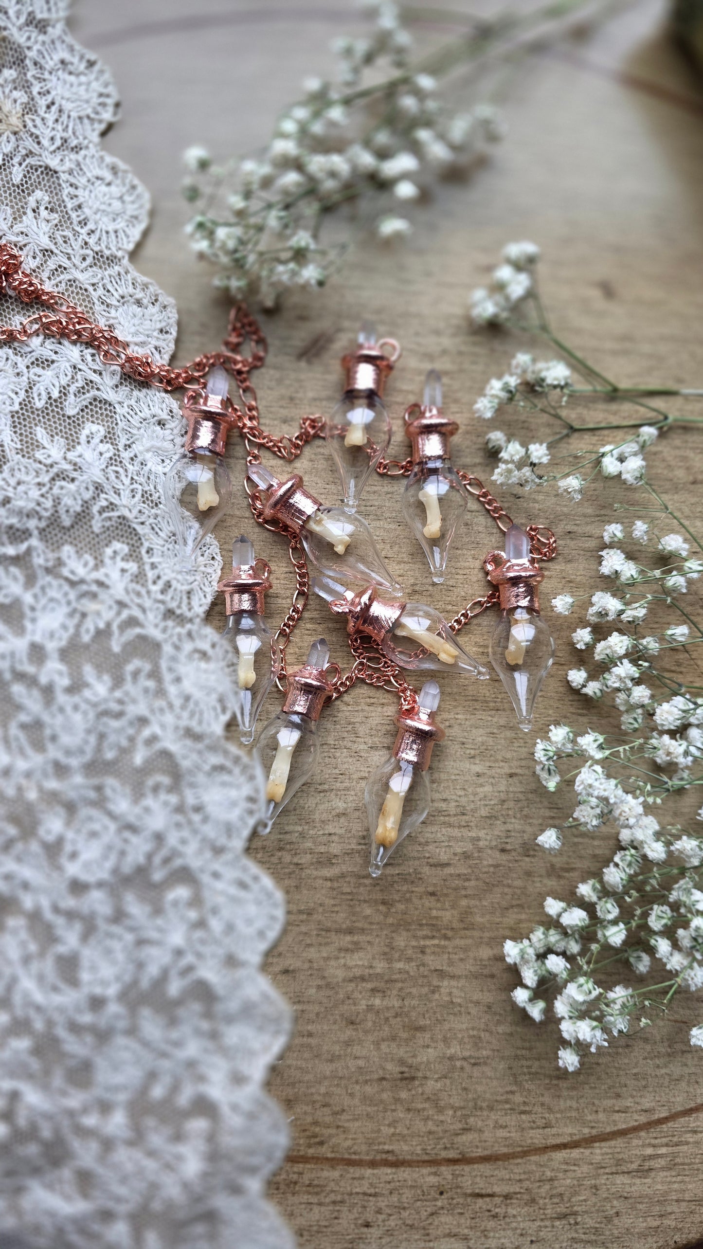 Black cat toe bone copper vial necklace.